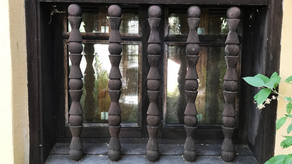 close up of carved wooden spindles on railing