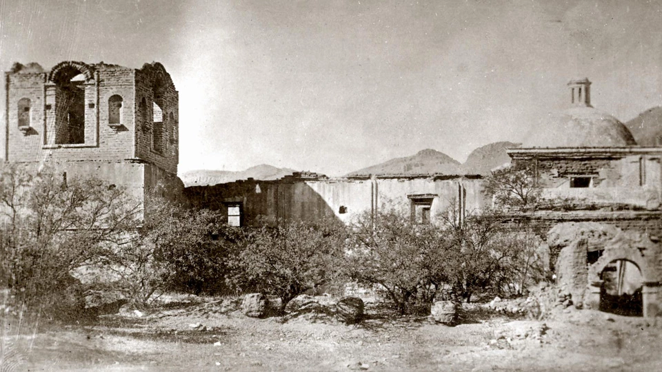 historic photo of east wall of church, with small nubs of pillars below