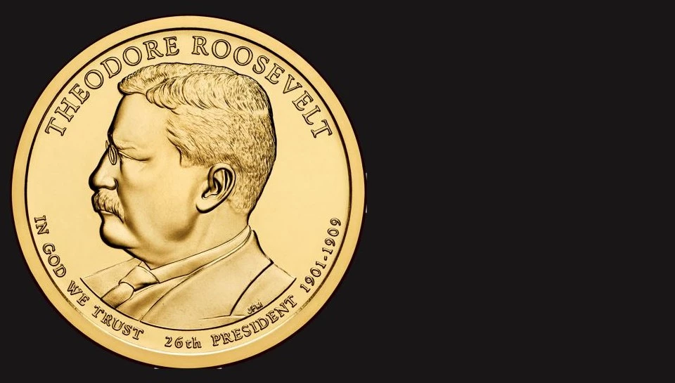 A gold dollar coin showing Teddy Roosevelt's image