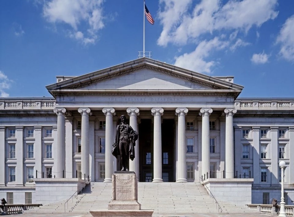 Black and white photo of the Treasury building with white stairs and stone columns