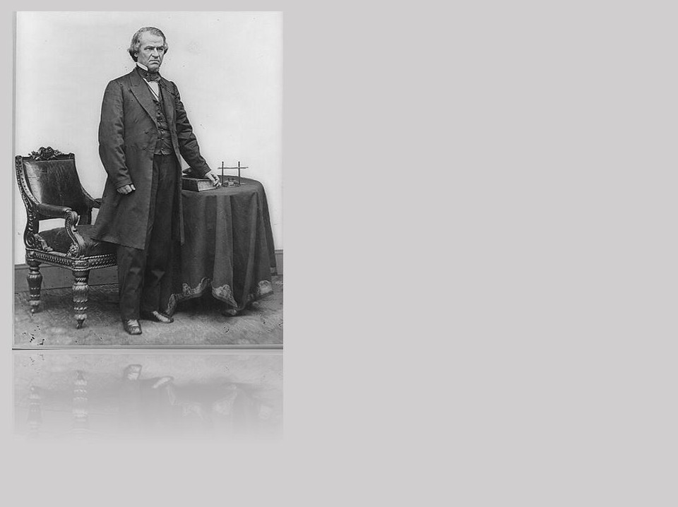 American flag waving in the breeze, the sun shining through the stars