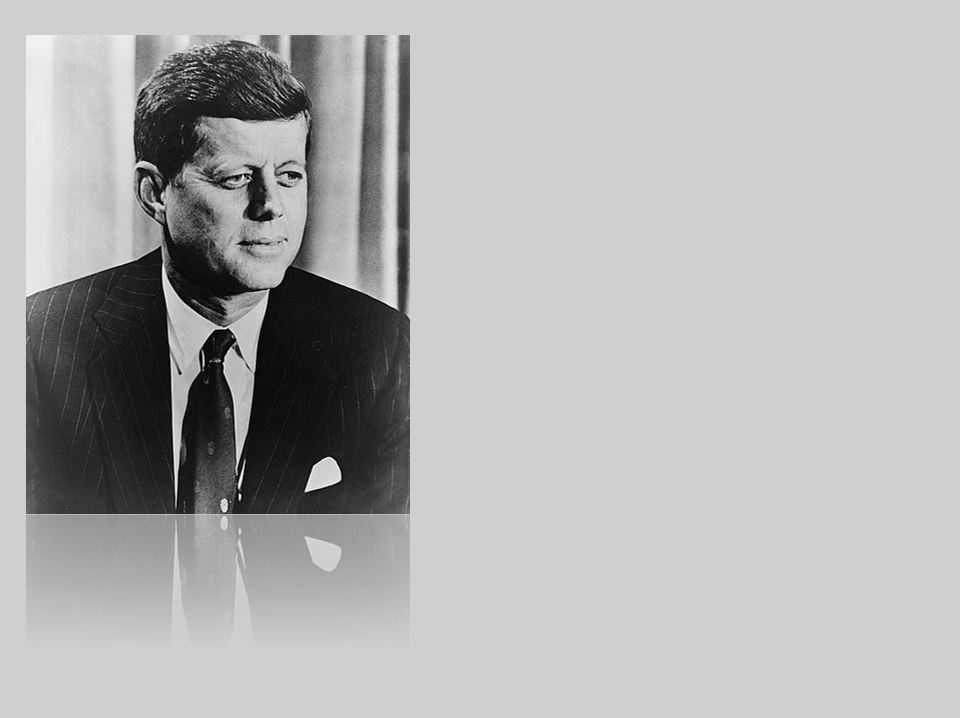 American flag waving in the breeze, the sun shining through the stars