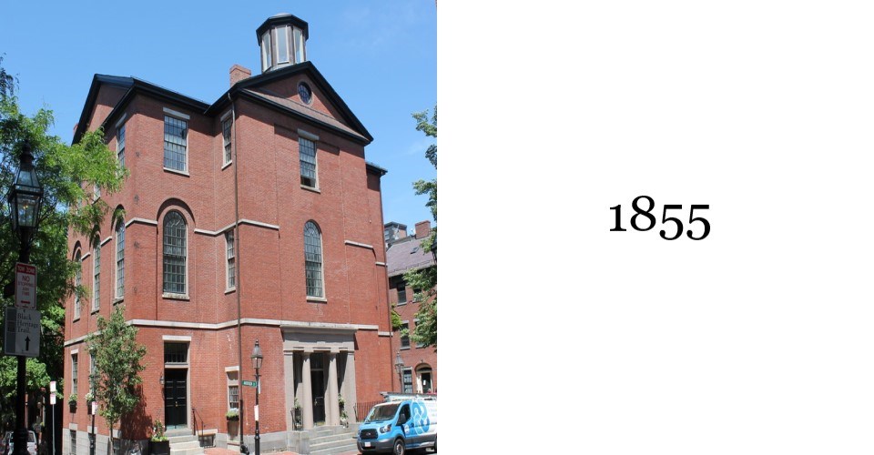 The Phillips School is a four story red brick building with a small tower or cupola on top.