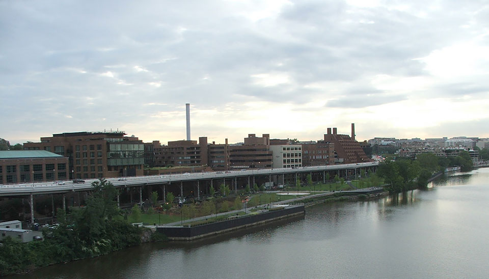A black and white image showing buildings crowded around the waterfront