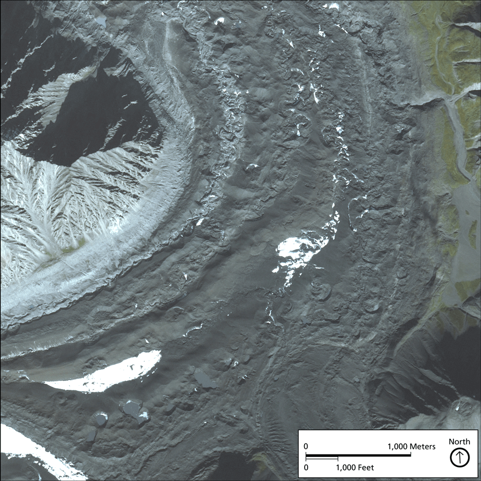 a rock-covered glacier curving around a mountain