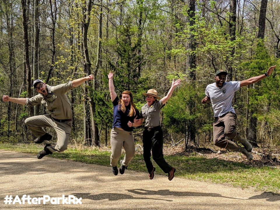 Four people unhappily working at a table