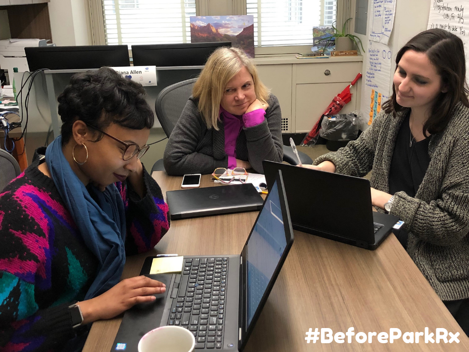 three unhappy people at a desk working