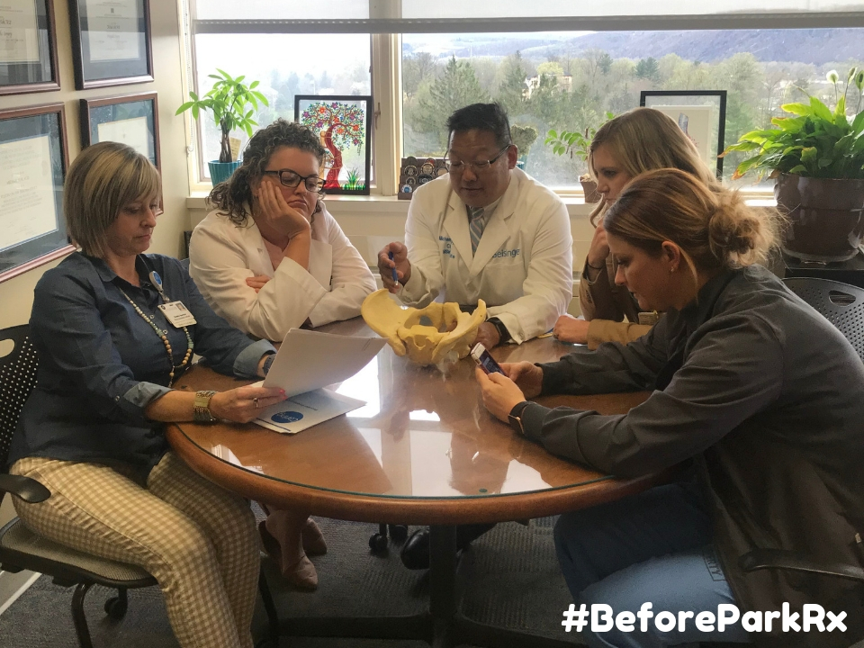 Doctors and medical staff sitting around table