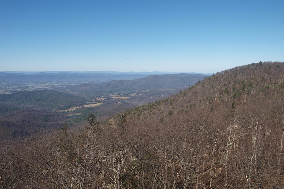 Clear early spring view from a mountain top of the Luray valley and tree topped ridges in the distance.