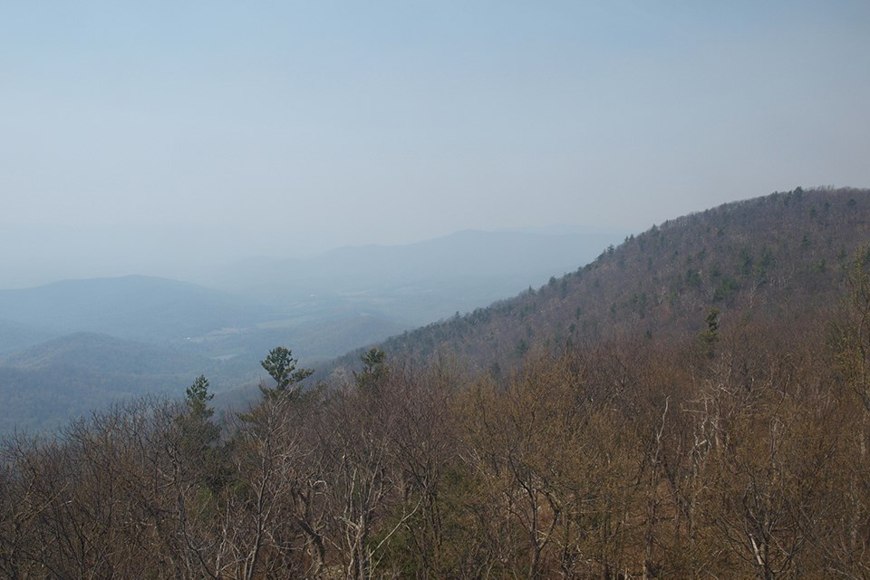Clear early spring view from a mountain top of the Luray valley and tree topped ridges in the distance.