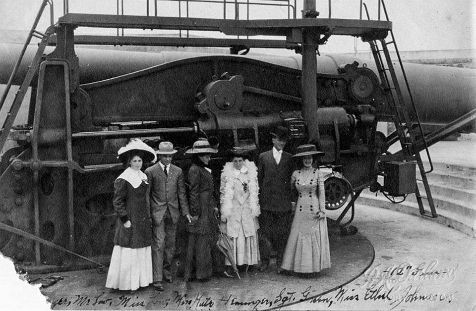 four women posing with a 12in gun