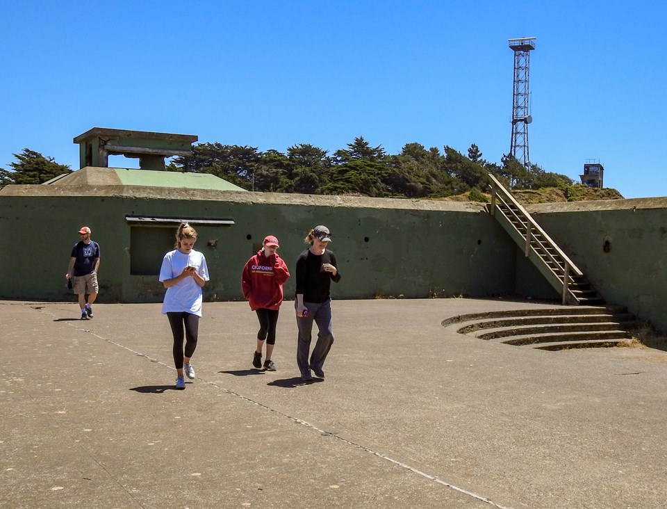 a group of soldiers loading projectiles into the disappearing gun