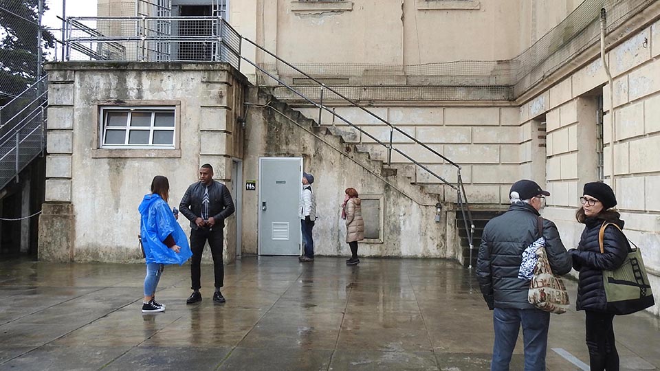 people walk around outside concrete stairs