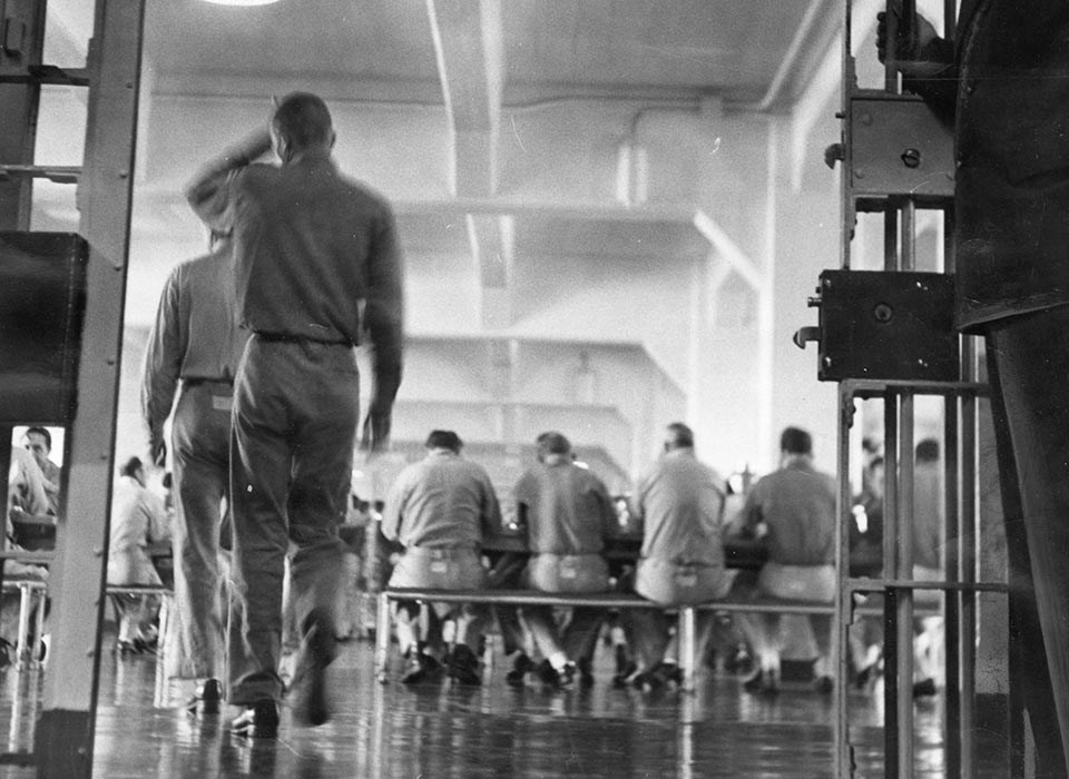 view of visitors in the Alcatraz dining hall from cell door