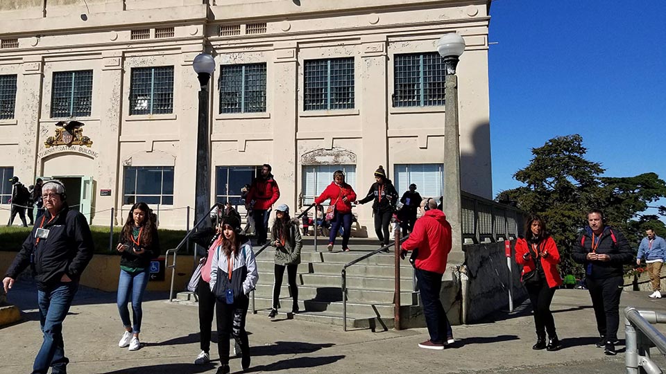 people walk outside of the cell house