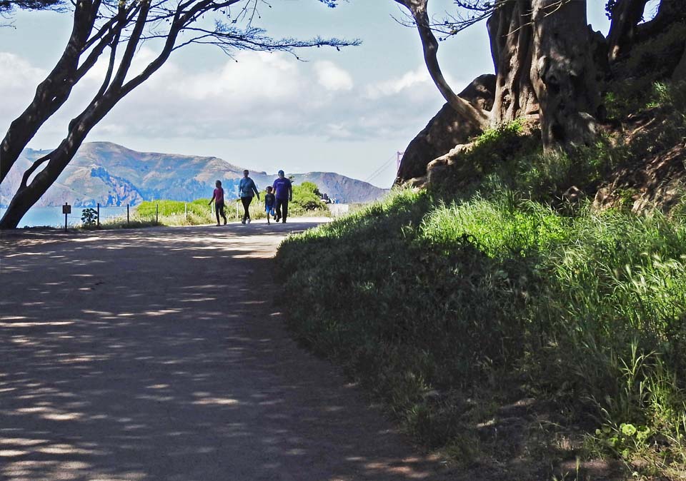 three people walk around a corner
