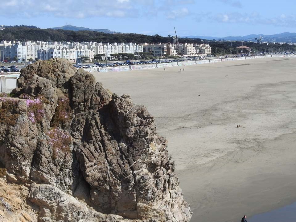a rock overlooking the beach