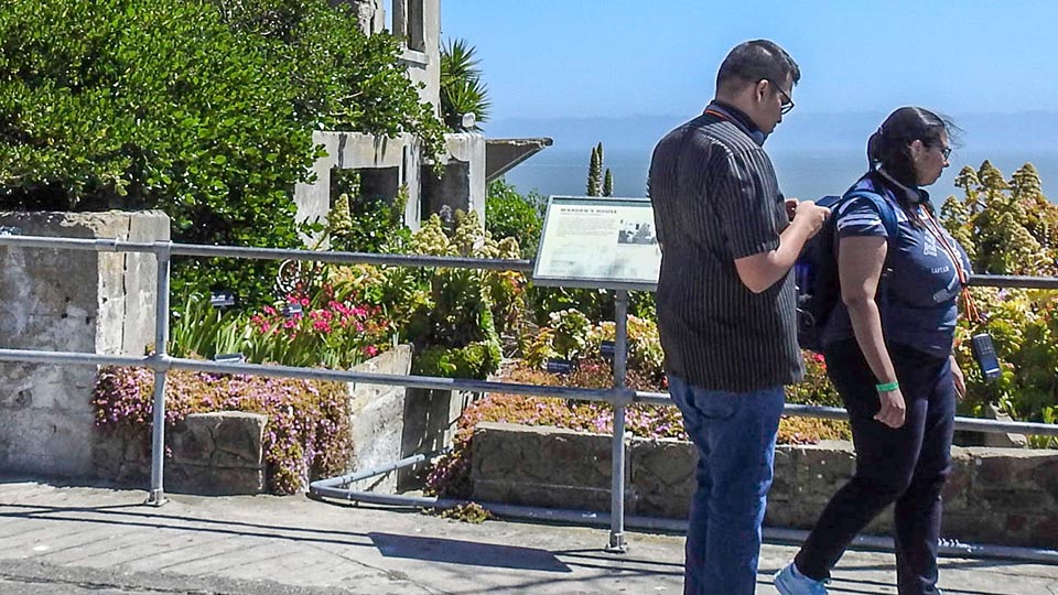 people walking by alcatraz garden
