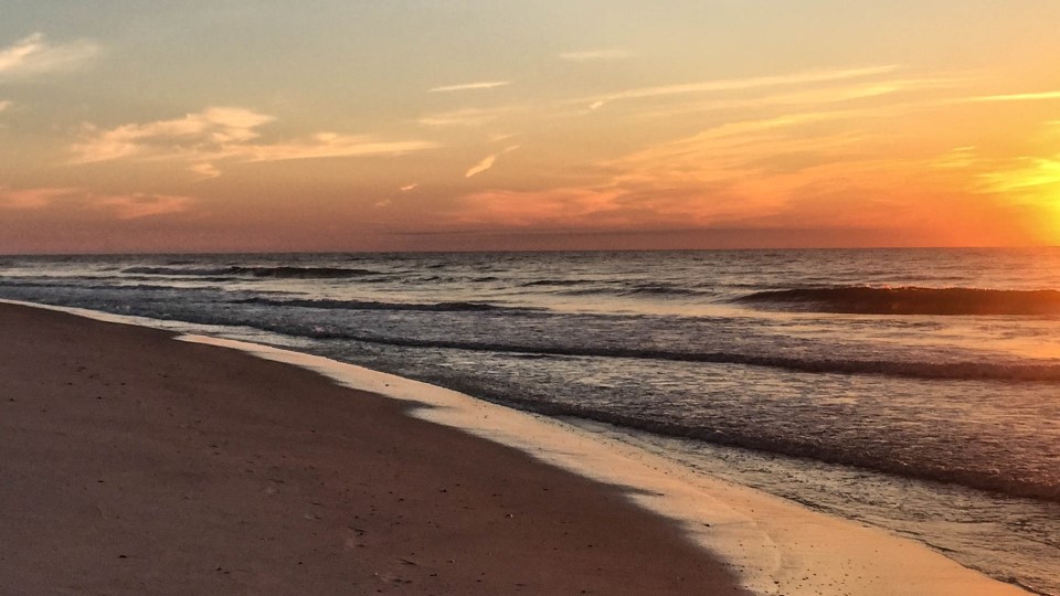 A sandy beach at sunrise