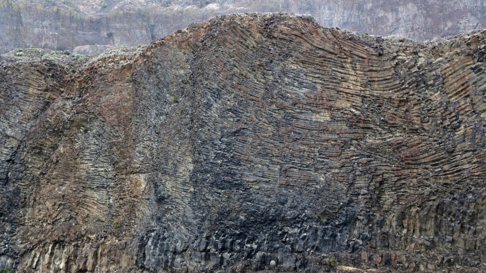 Lava pools and flows across a dark landscape