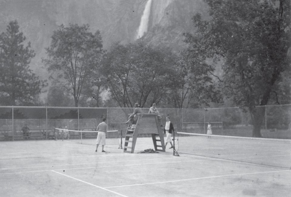 Ahwahnee tennis courts with a few players in 1930, clear view to Yosemite Falls.