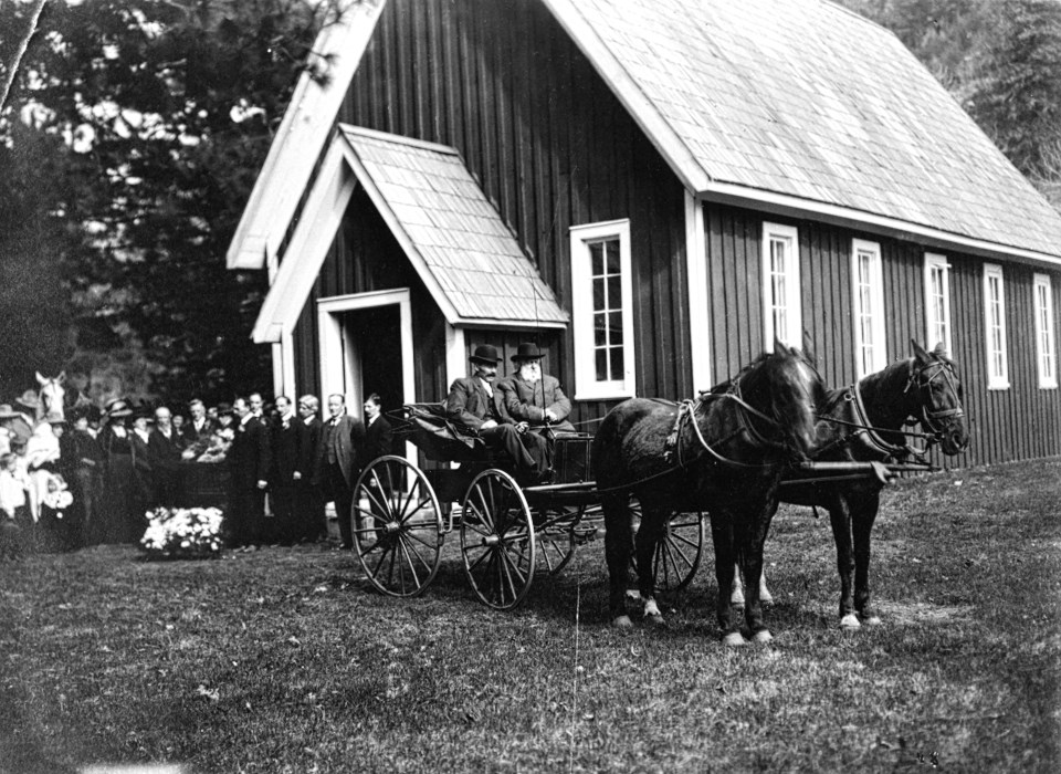 Horses and buggy in front of chapel