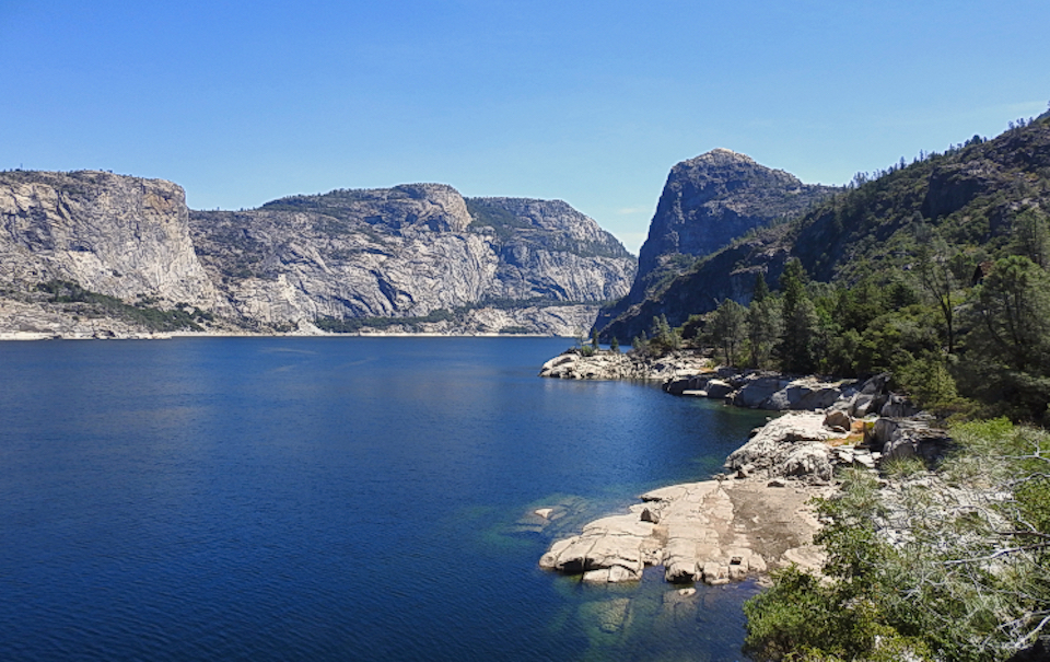 Color painting of valley with cliffs and trees, meadows