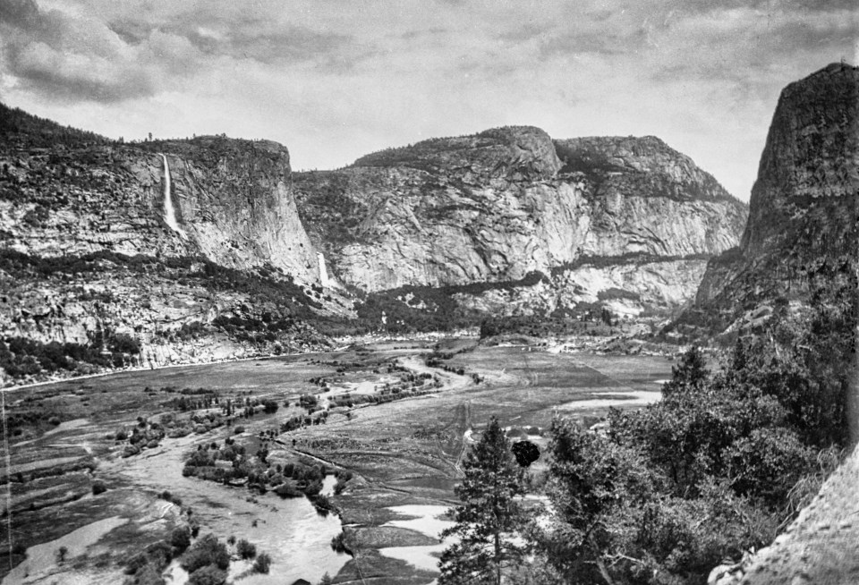 A large valley surrounded by cliffs and waterfalls.