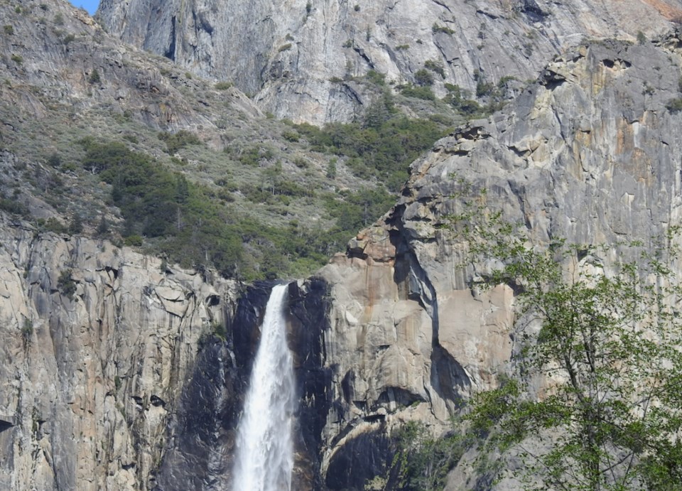 Watercolor painting of cliffs and waterfall.
