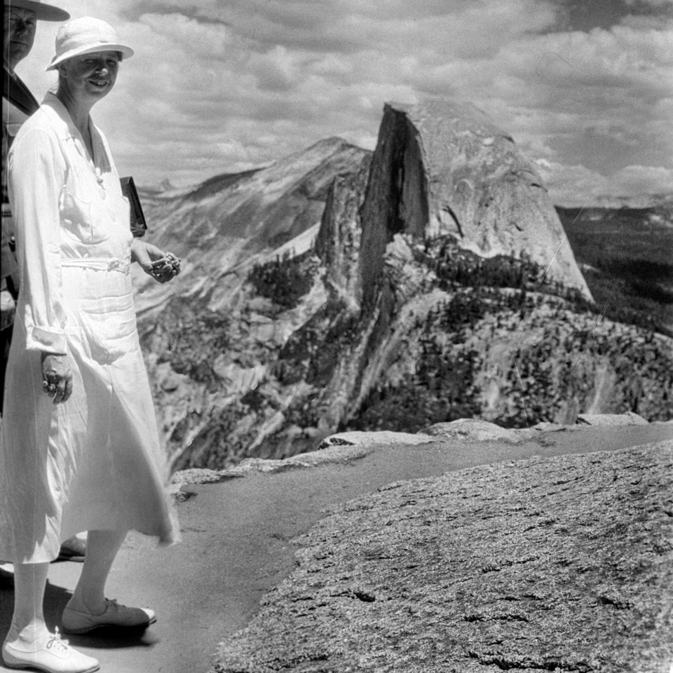 First Lady Eleanor Roosevelt standing on a rock slab with granite cliffs in the background.