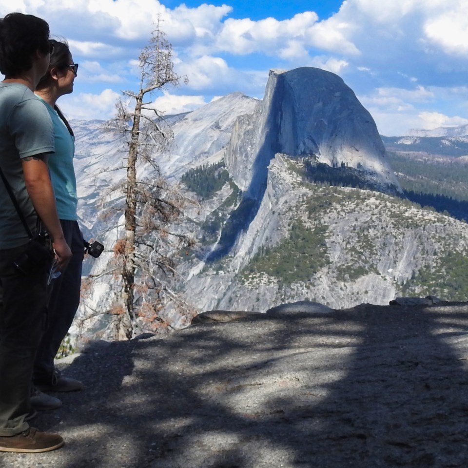 First Lady Eleanor Roosevelt standing on a rock slab with granite cliffs in the background.