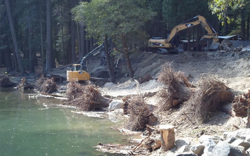 Housekeeping Camp riverbank with large riprap (rocks) in foreground.