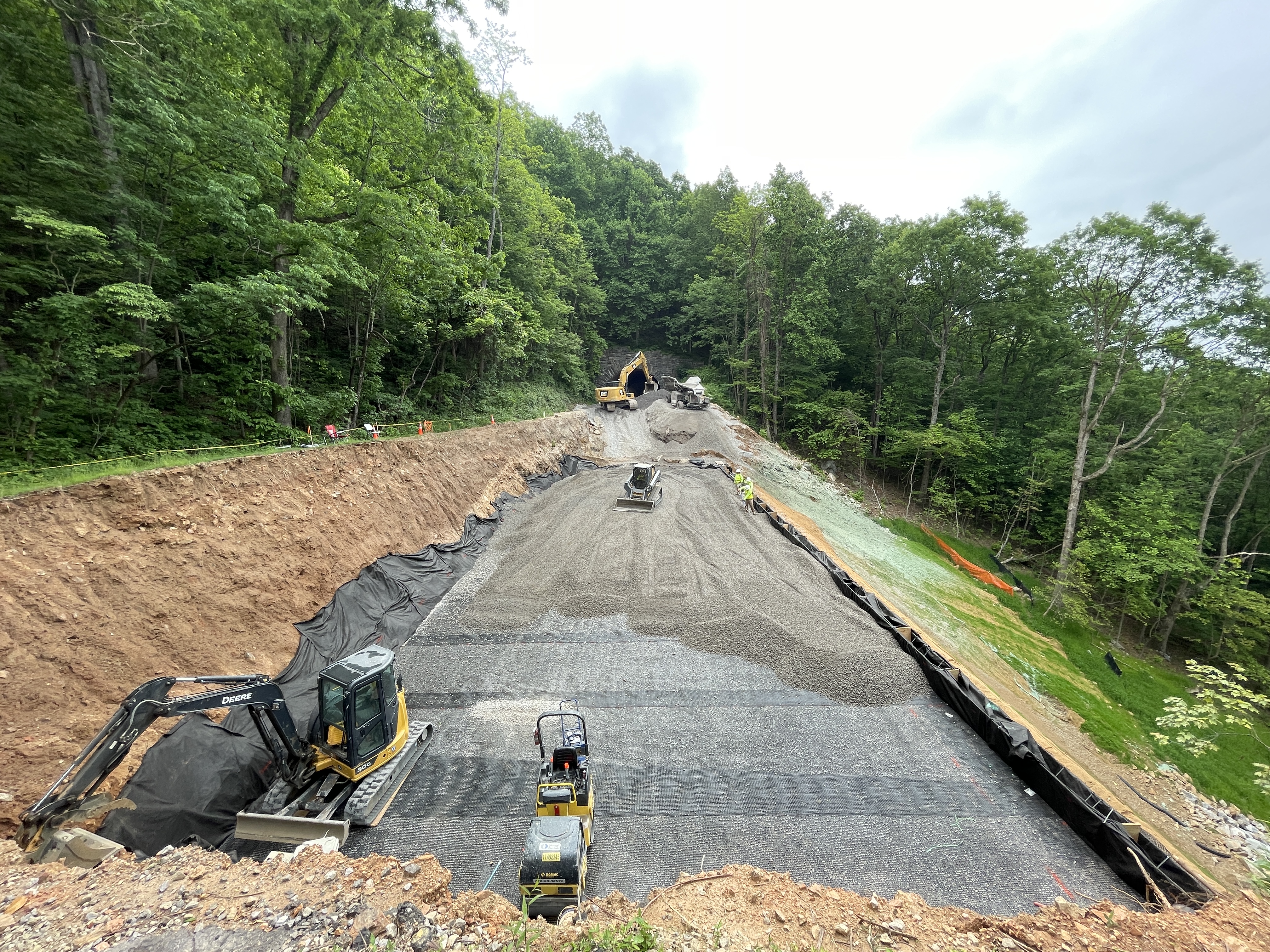 Crews work to rebuild the roadway and slope near Ferrin Knob Tunnel #3 after Hurricane Helene.
