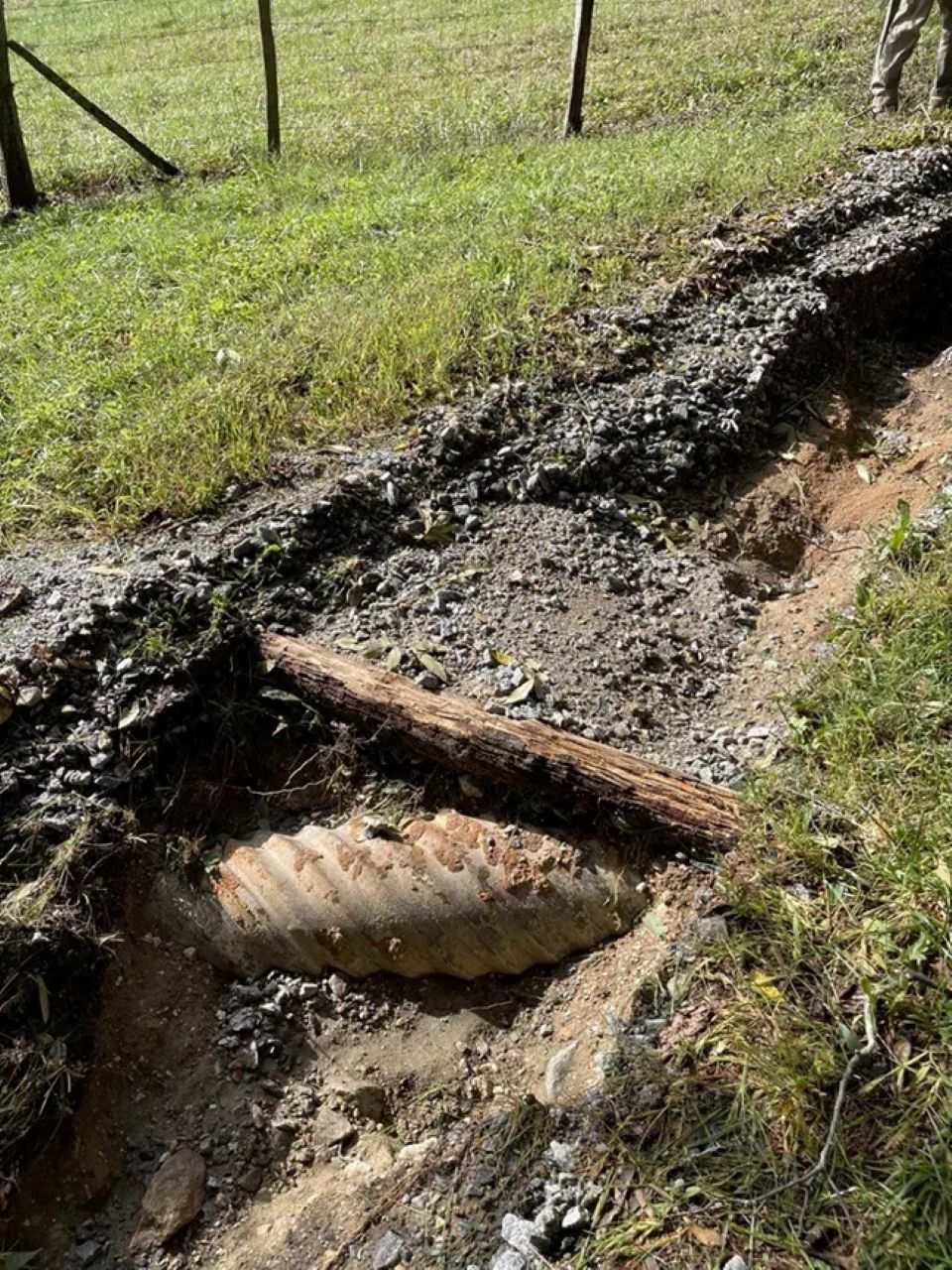 A gravel trail that was completely washed away, underground pipe exposed