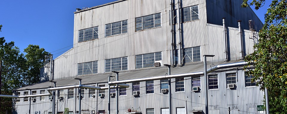 Large industrial building with many windows.