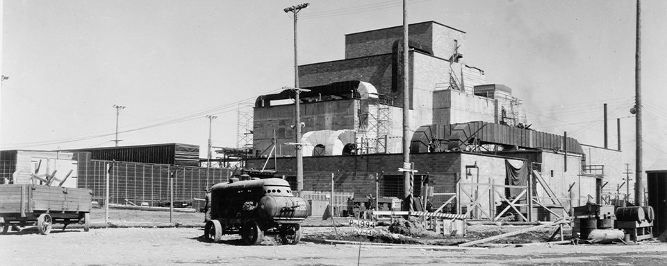 A black and white photo of a blocky, industrial-looking building.