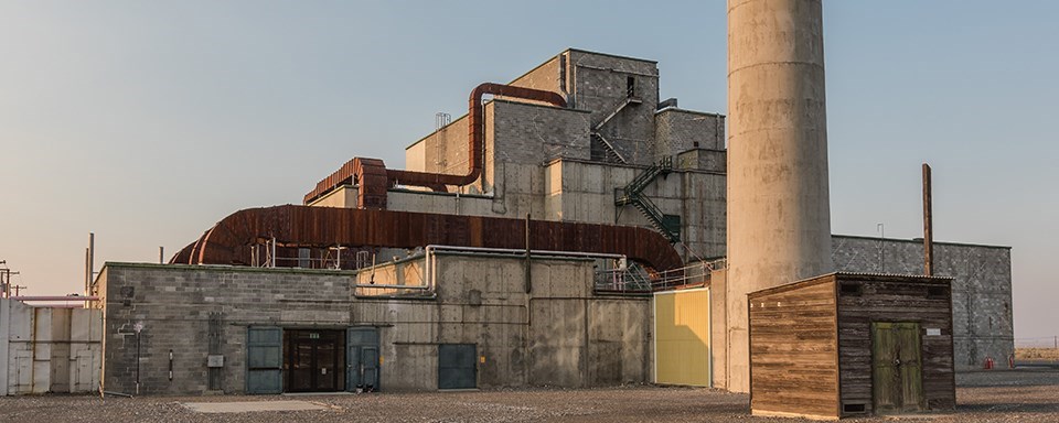 A black and white photo of a blocky, industrial-looking building.