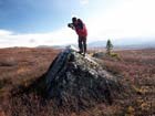 man standing on a boulder