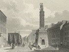 Battle monument in Baltimore surrounded by street scene.