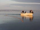 five people in a small boat