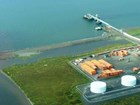aerial view of buildings and a pier sticking out into the ocean