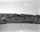 The comfort station and trail building stand at a point of prominence on the hillside.
