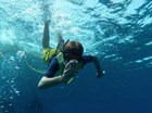 kid underwater taking a photo