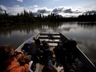 a group of boaters sit back and watch the Alaskan scenery
