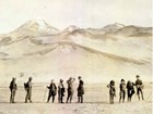 a group of people stand with mountains in the distance