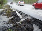 cars driving on a road covered in water