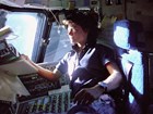 In orbit above the Earth, Sally K. Ride monitors flight status from the Space Shuttle Challenger