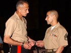 Major General Christopher Cortez (left) honors Staff Sergeant Eric Alva.