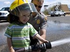 Boy holds a fire hose