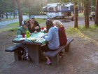 Four people sitting at a picnic table